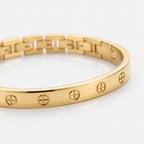 Amore Bangle Band in gold — close-up of the cross motifs along the cuff