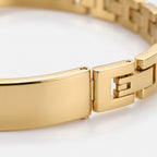 Positano Bangle Band in gold — close-up of the polished cuff meeting the link chain